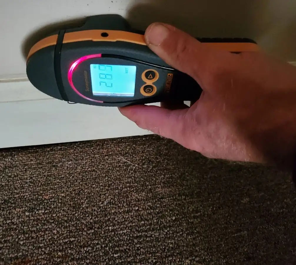 Moisture detection at baseboard during Storm Damage Restoration in South Kingstown